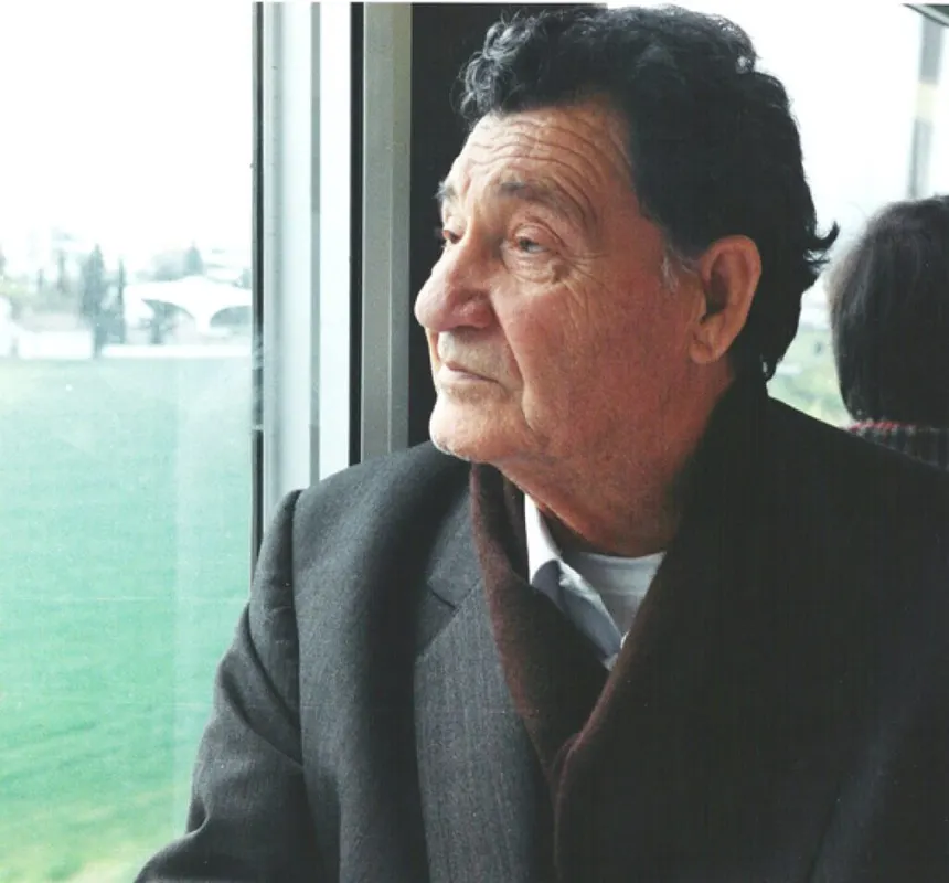 Stylianos Atteshlis, called Daskalos, seated in contemplation by a window overlooking green fields